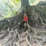 Louise sitting in the giant roots of a tree